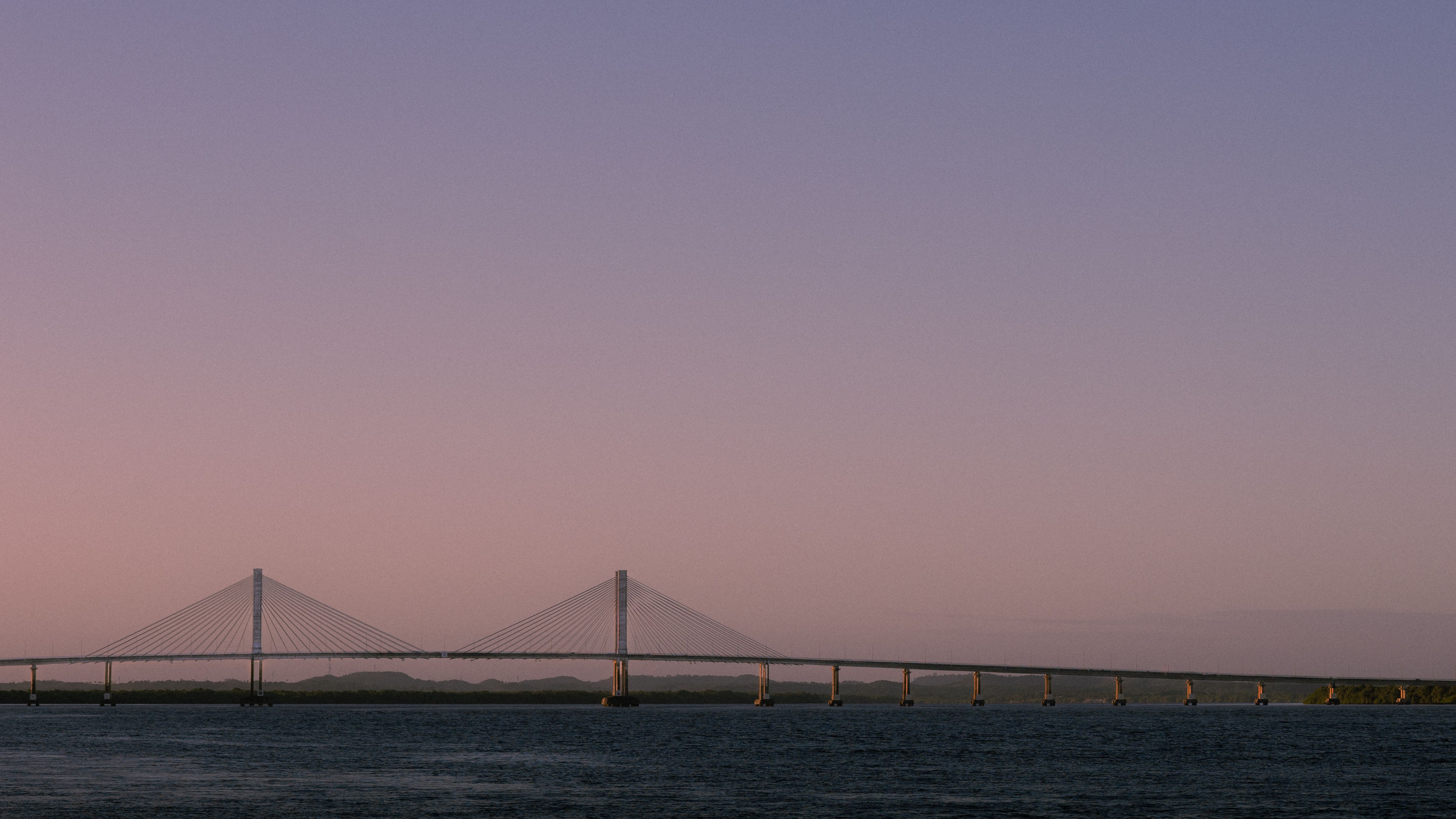 Stunning Bridge Silhouette at Sunset Over Water · Free Stock Photo