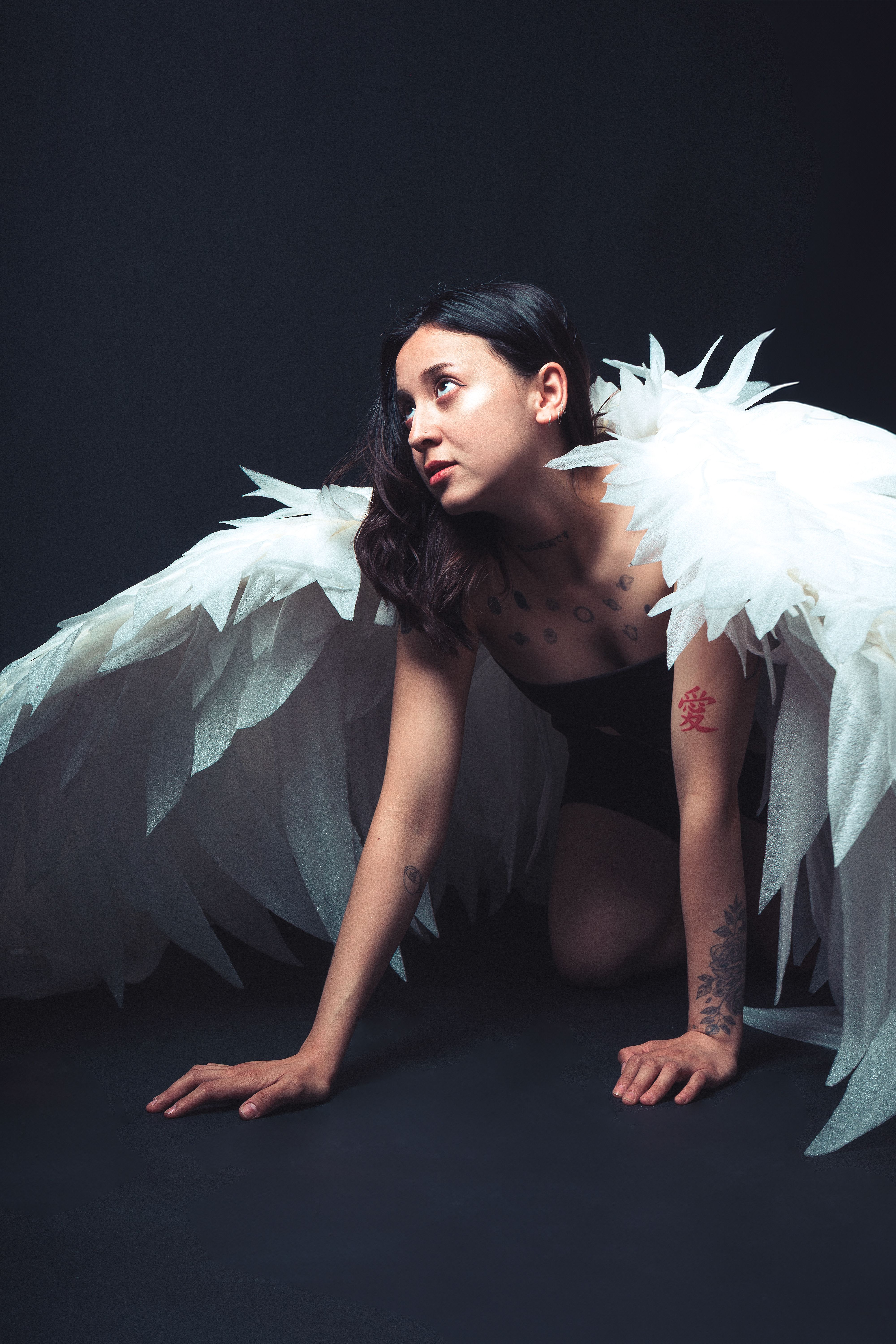 Fantasy Concept with Woman Crouching in Angel Outfit · Free Stock Photo