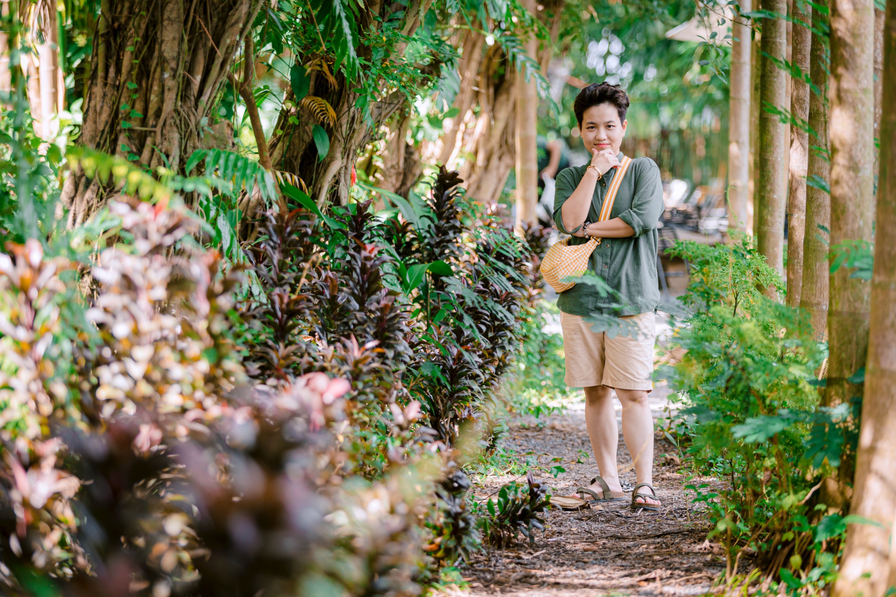 Woman Enjoying a Walk in Lush Green Garden · Free Stock Photo