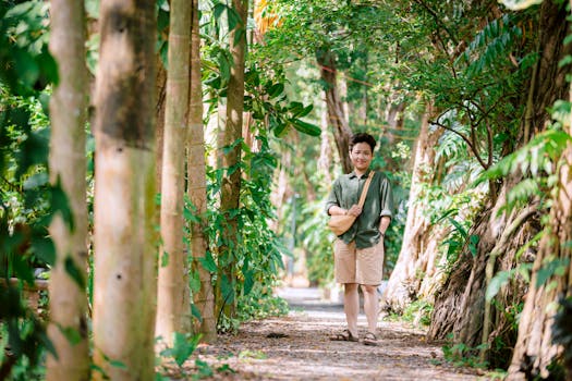 Person enjoys a serene walk through a sunny, lush green forest pathway. Vibrant summer scene.