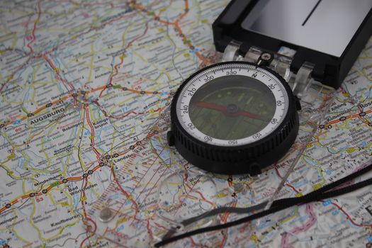 Compass positioned on a detailed map of Bavaria highlighting Augsburg.