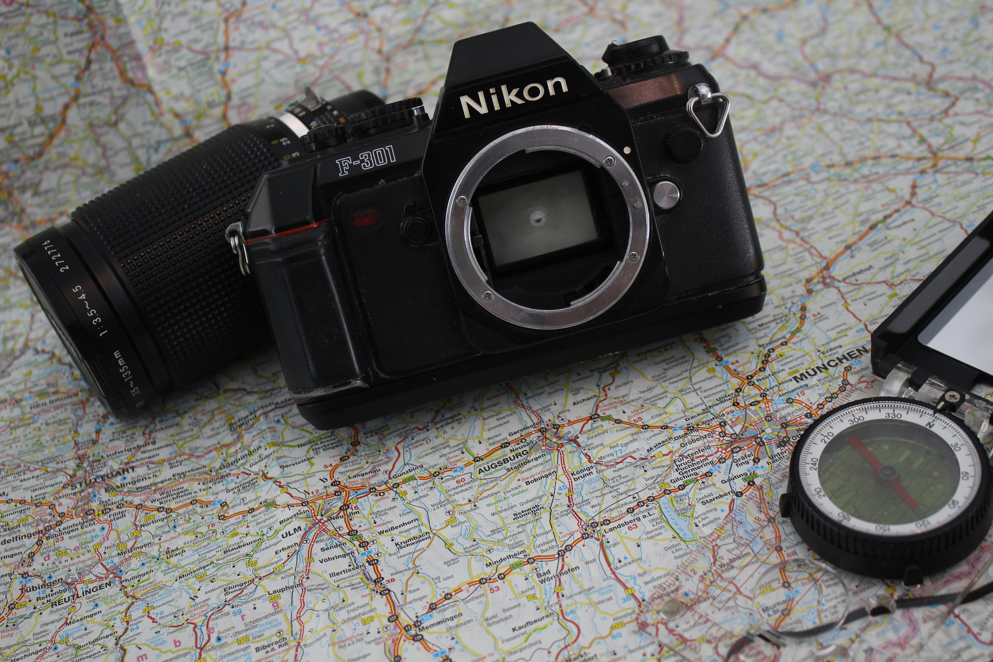 Explore travel and photography with a classic camera and compass on a detailed world map.