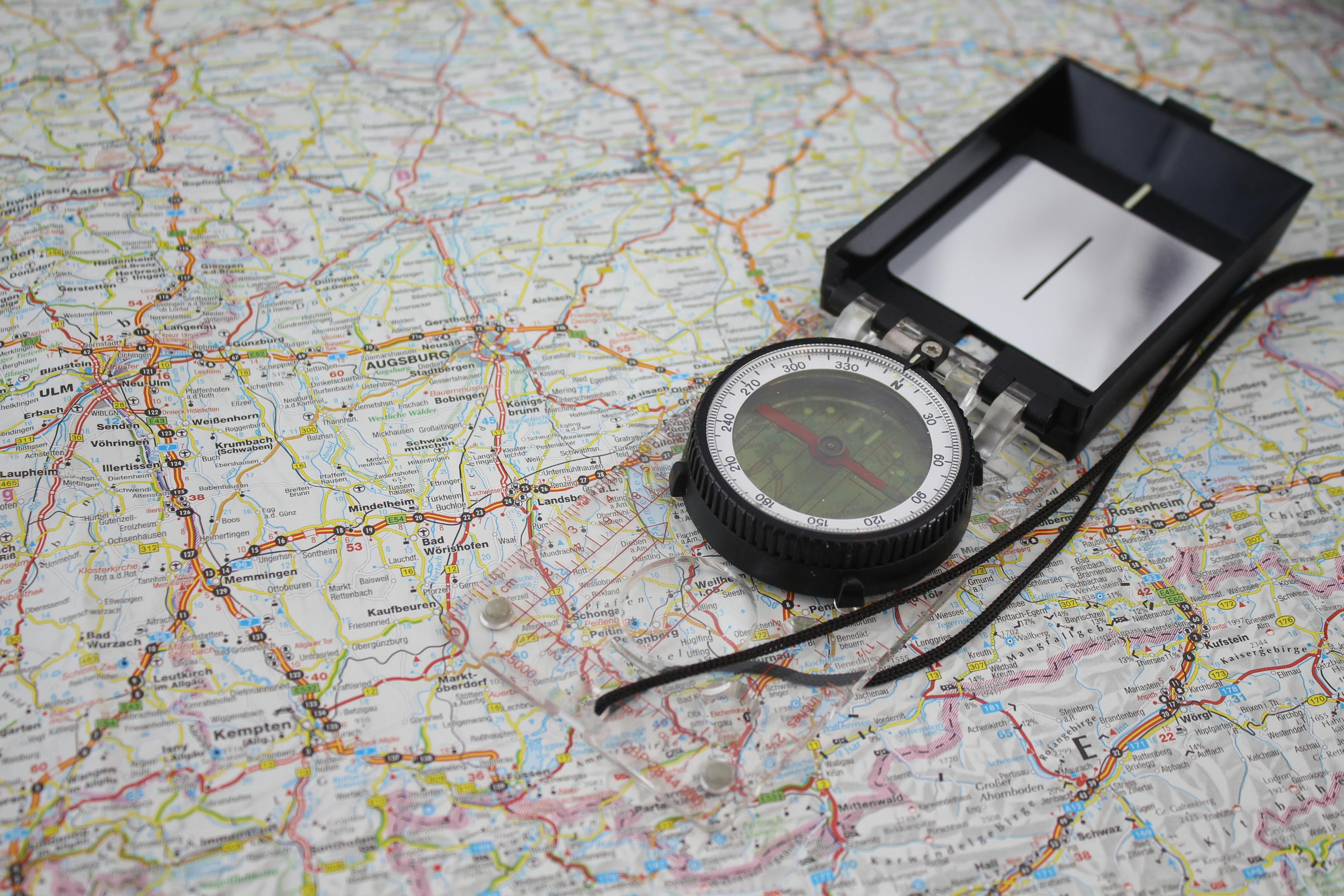 Close-up of a compass on a detailed map of Germany, ideal for travel and navigation themes.