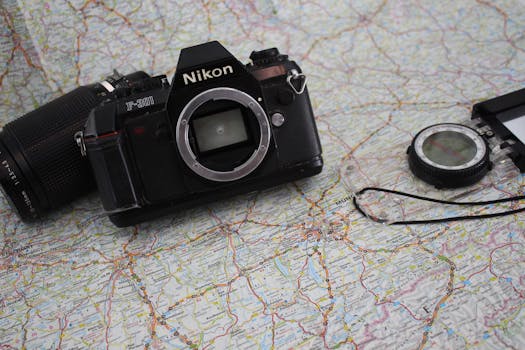 Explore with a vintage Nikon camera on a detailed travel map, perfect for adventure enthusiasts.