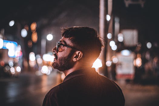 A captivating portrait of a man in Pune, India, with vibrant city lights at night.