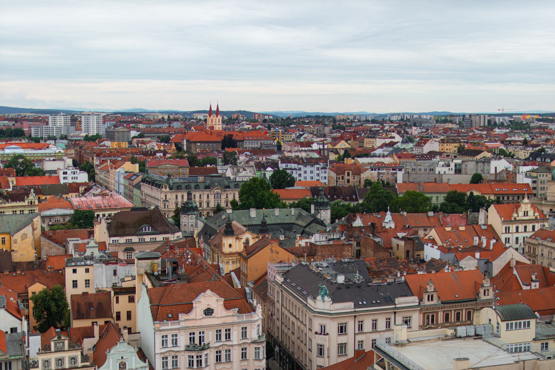 Aerial view of vibrant rooftops and architecture in Plzeň, Czech Republic, showcasing historical charm.