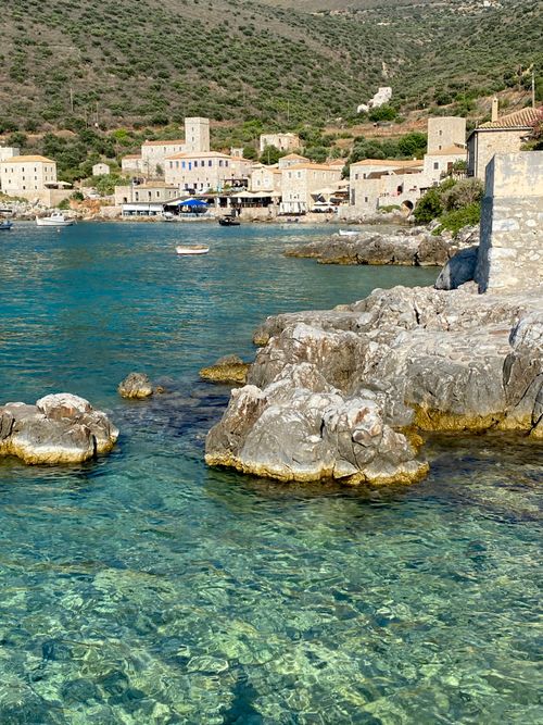 Free Charming coastal village with stone houses and turquoise waters in Greece, a perfect travel destination. Stock Photo