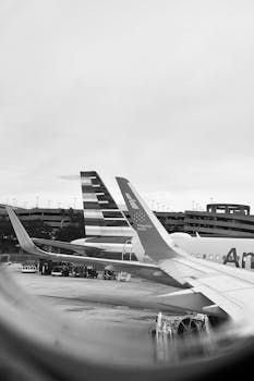Captivating black and white image of an airplane on the runway, showcasing travel ambiance.