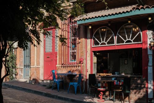 Free Explore a quaint café in Istanbul's colorful Balat district, capturing the vibrant street life. Stock Photo