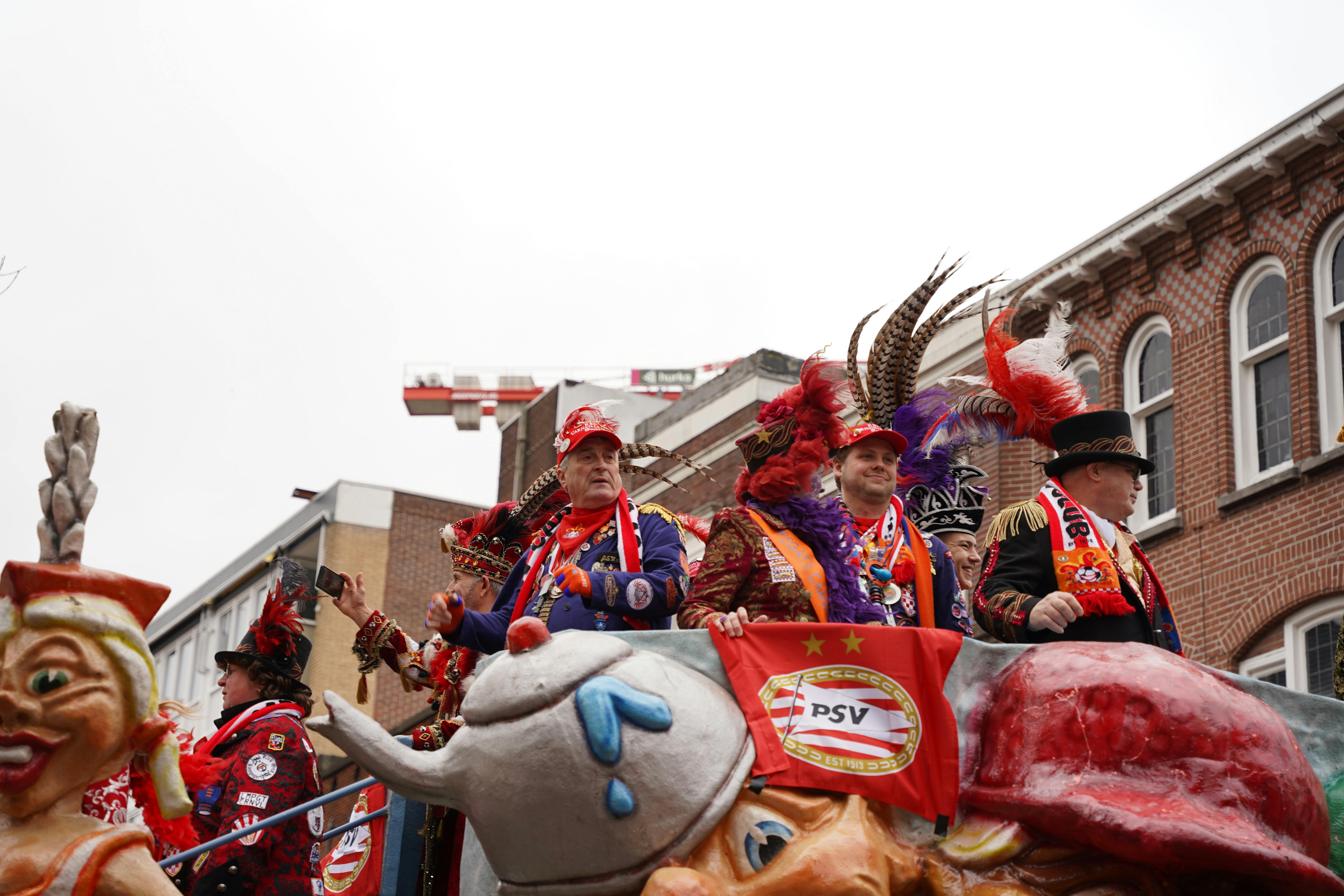 Colorful and lively carnival parade in Holland showcasing traditional costumes and vibrant masks.