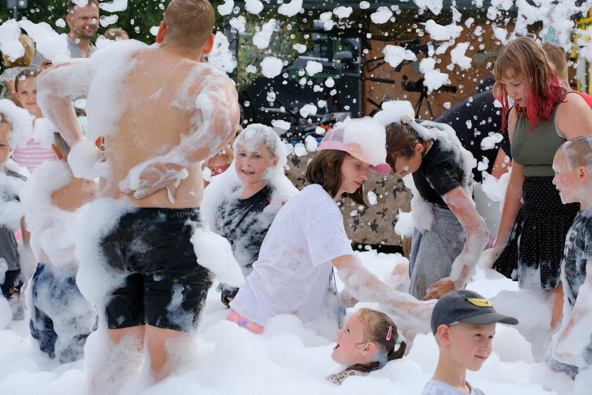 Foam party guests playing outdoors