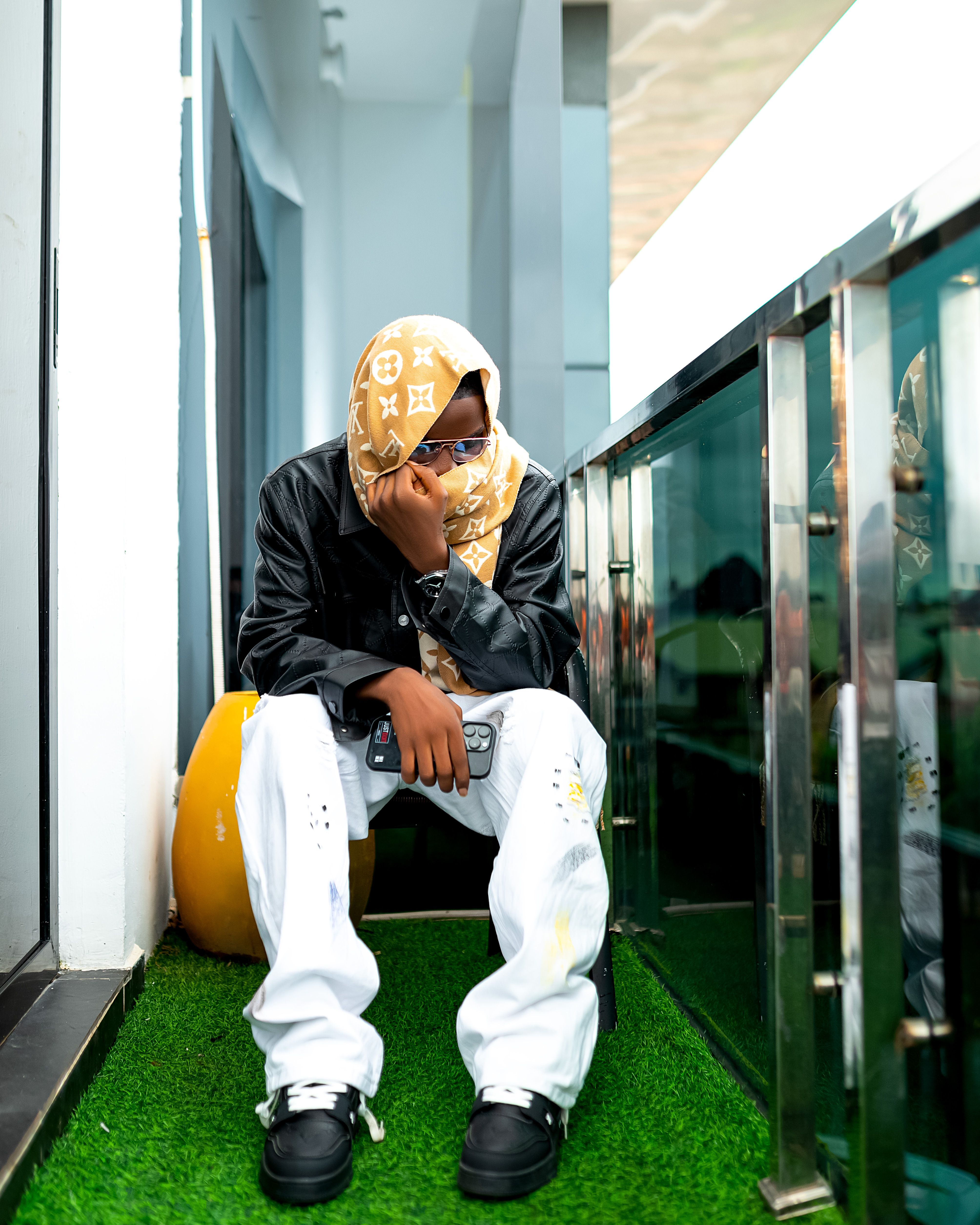 A fashionable young adult in a modern setting, reflecting urban style and attitude.