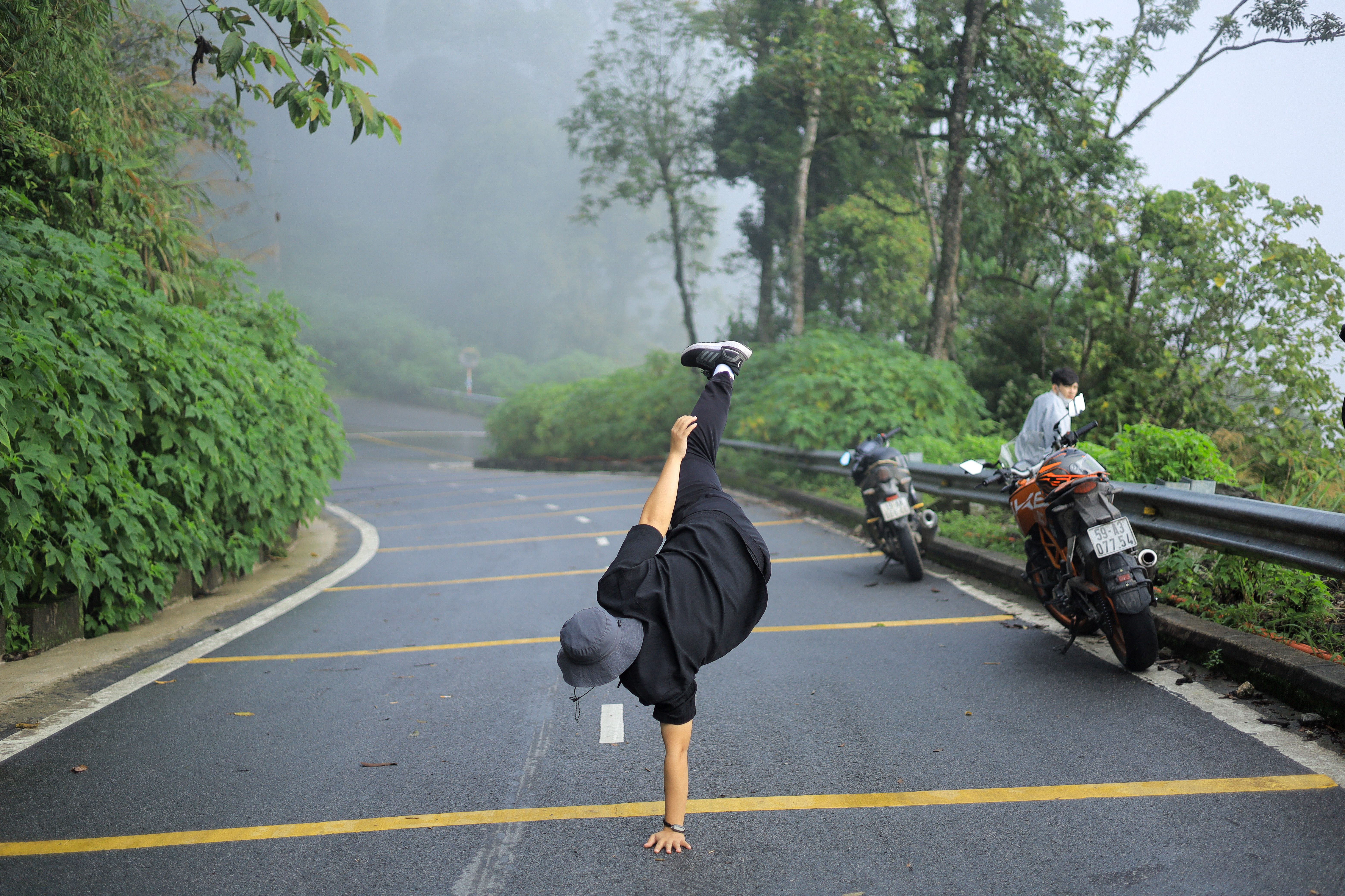 Dynamic Breakdancer on Misty Vietnamese Road · Free Stock Photo