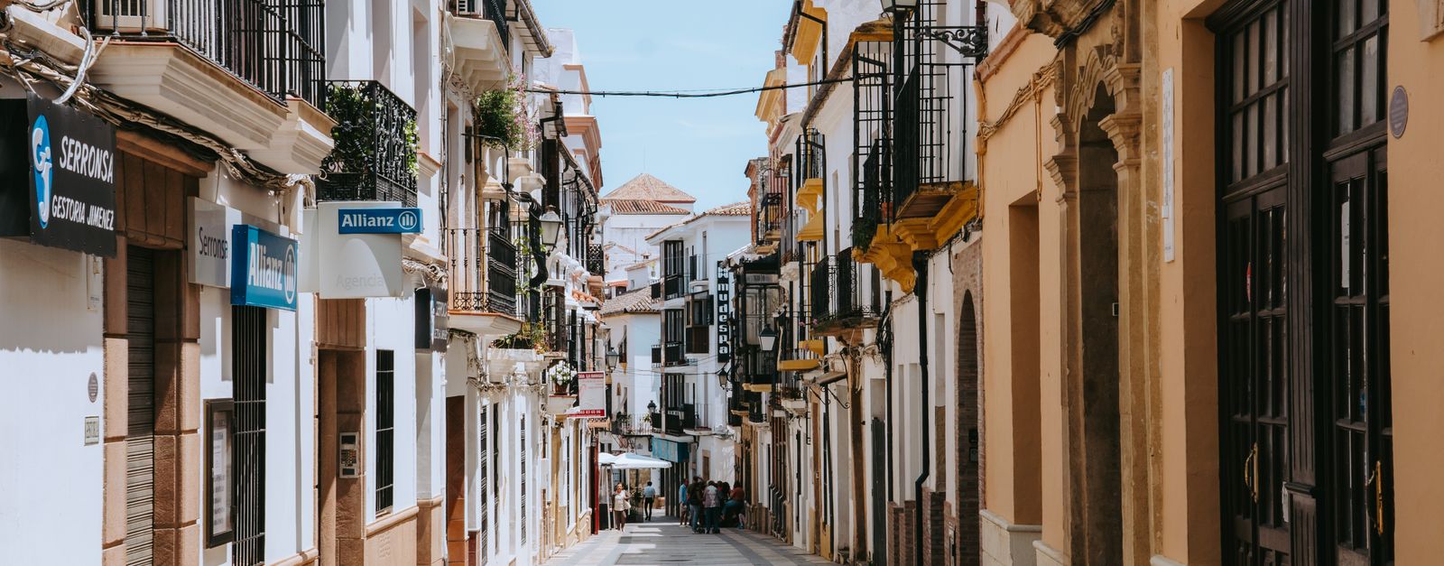 Explore the picturesque architecture of a quiet street in Ronda, Spain.