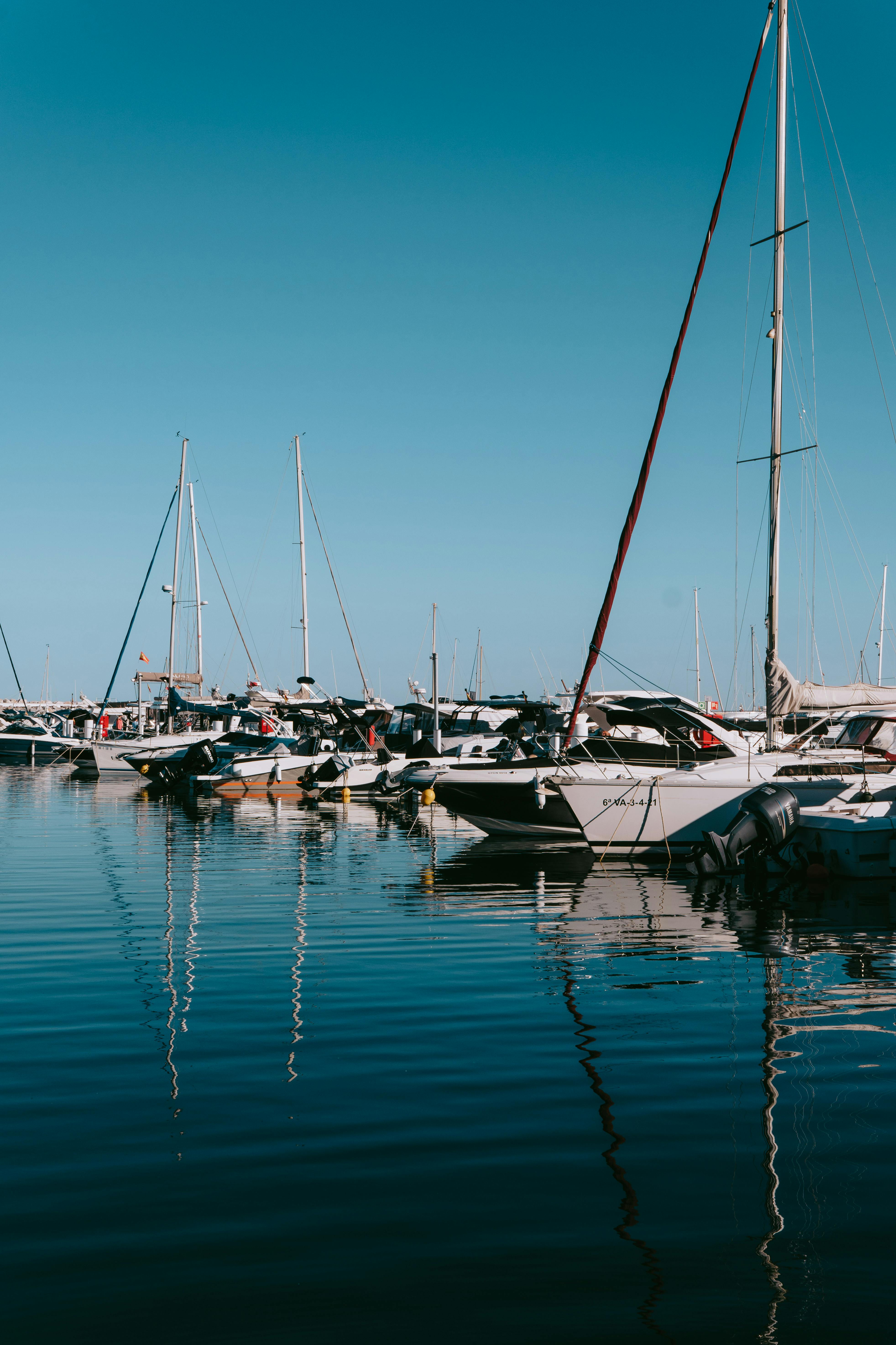 Free Luxury yachts docked at Puerto Banus marina, reflecting a sunny day in Marbella, Spain. Stock Photo