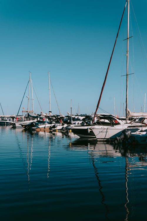 Free Luxury yachts docked at Puerto Banus marina, reflecting a sunny day in Marbella, Spain. Stock Photo