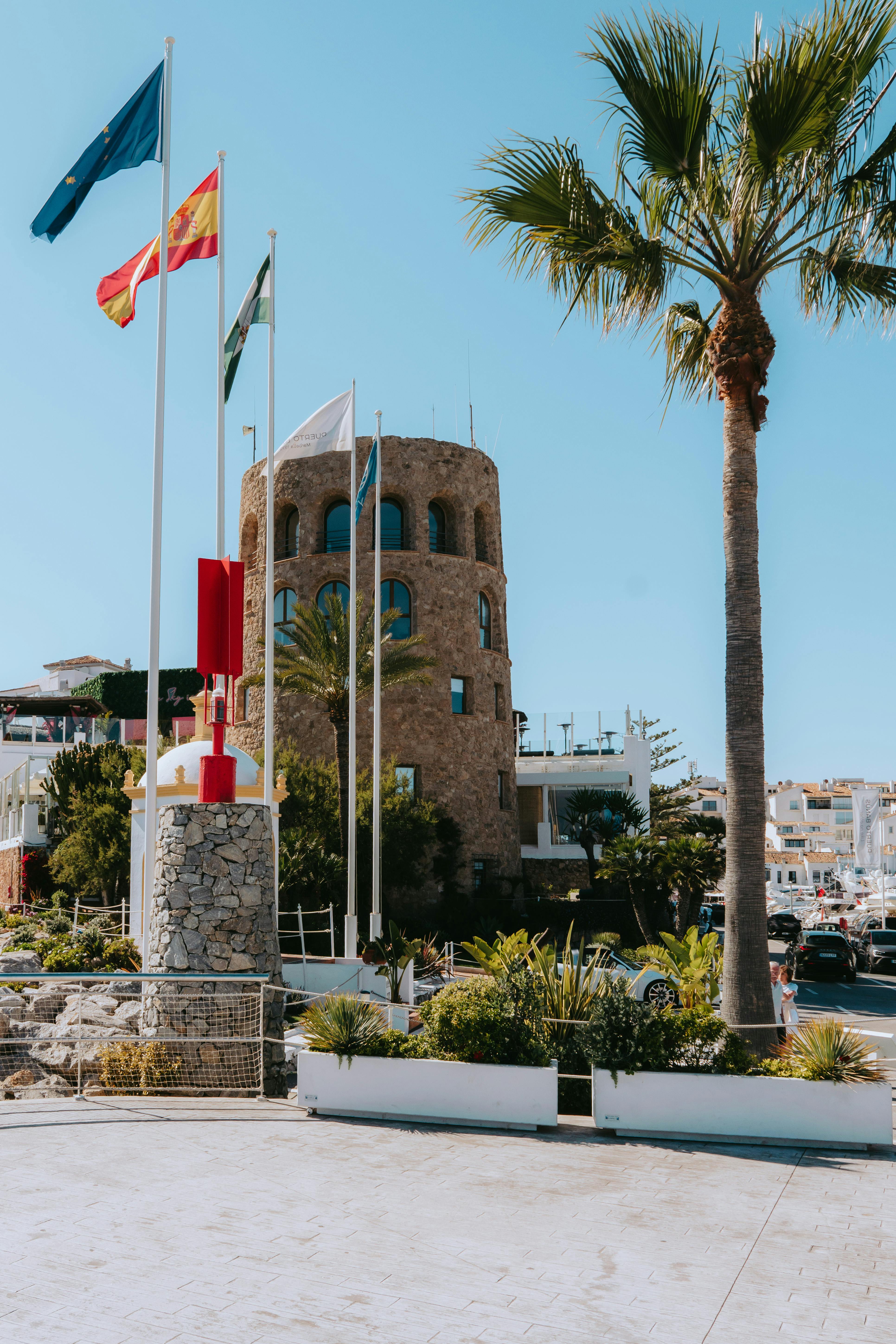 Free Charming view of Marbella harbor, capturing coastal elegance and Mediterranean architecture under a bright summer sky. Stock Photo