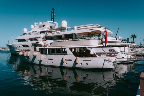 Free Elegant yachts docked at the picturesque Puerto Banus Marina under a clear blue sky. Stock Photo