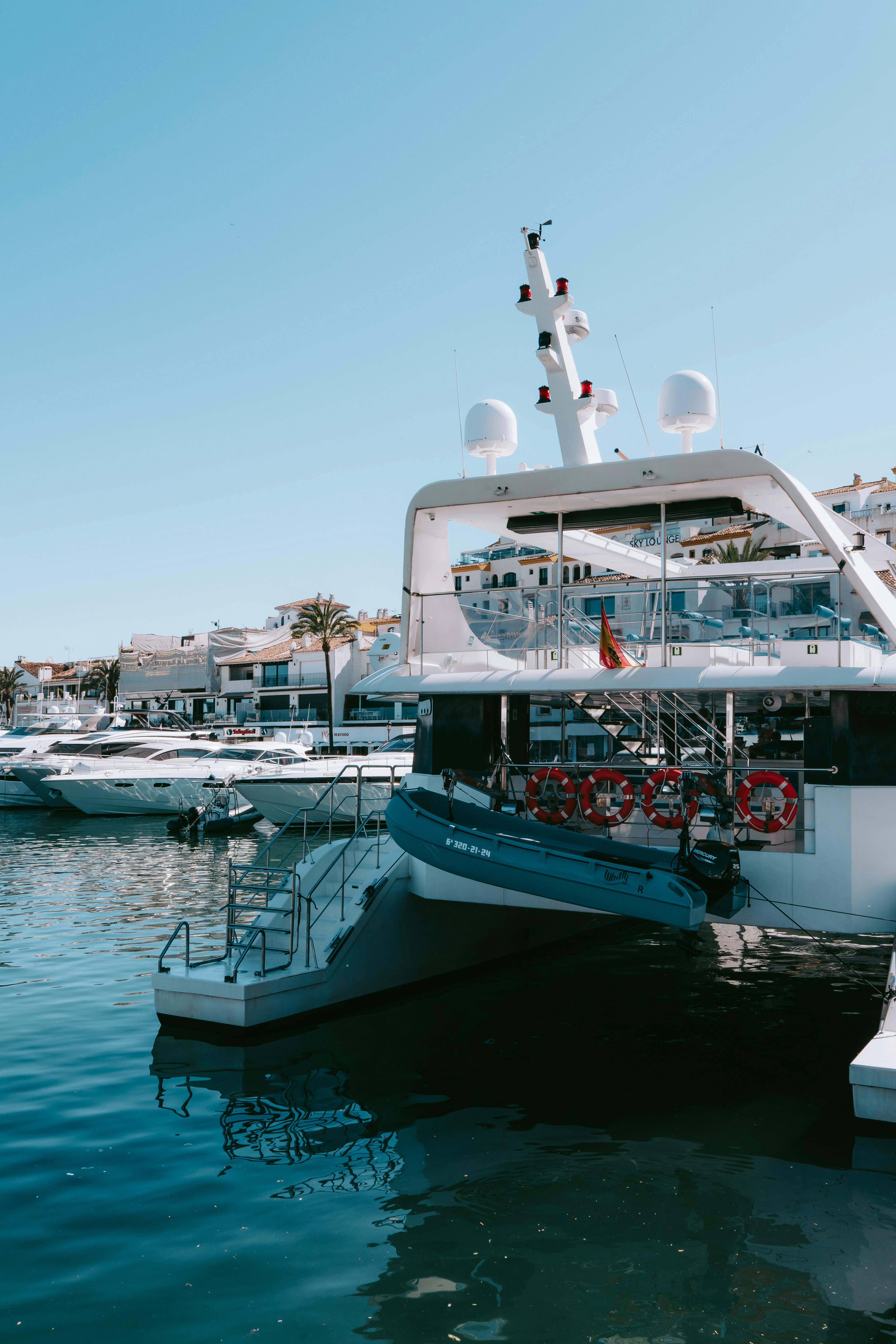 Free Explore luxury yachts docked at Puerto Banús Marina, Marbella, in a vibrant Mediterranean setting. Stock Photo