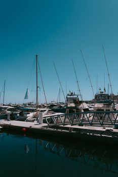 Explore the exquisite marina with yachts in Marbella, Andalusia, Spain, under a clear summer sky.