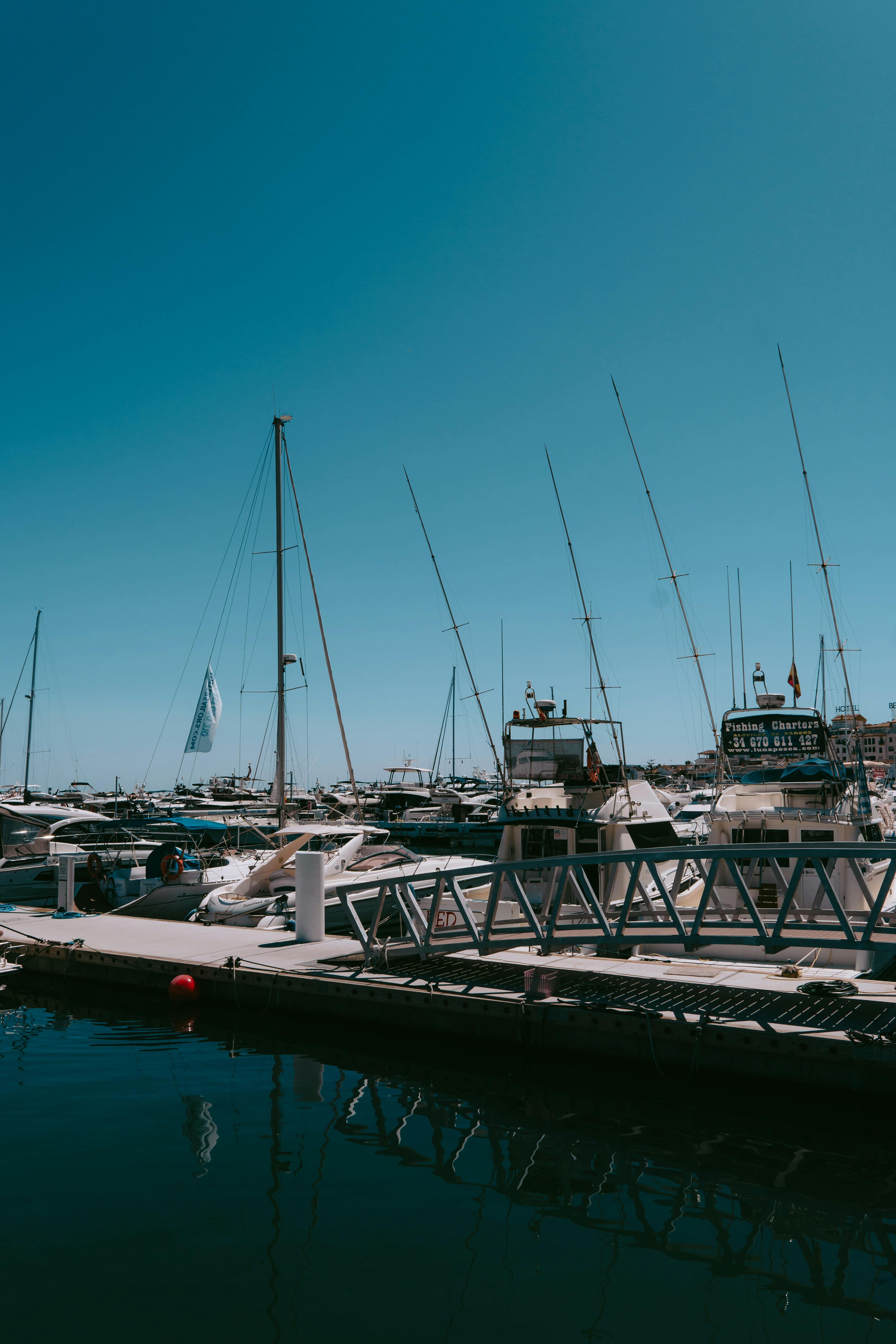 Free Explore the exquisite marina with yachts in Marbella, Andalusia, Spain, under a clear summer sky. Stock Photo