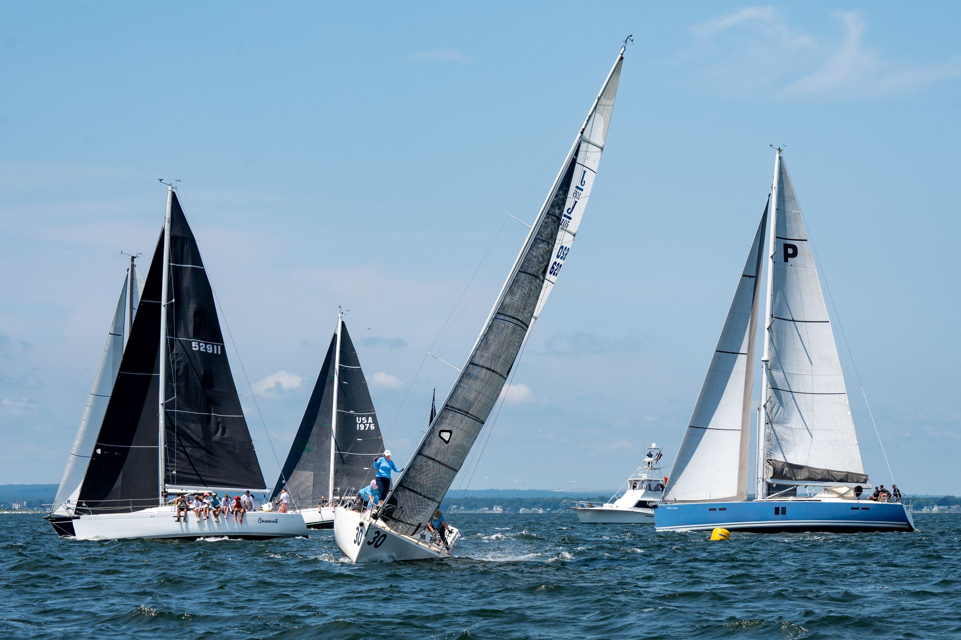 Dynamic sailboats racing on a sunny day in Narragansett Bay, Rhode Island.