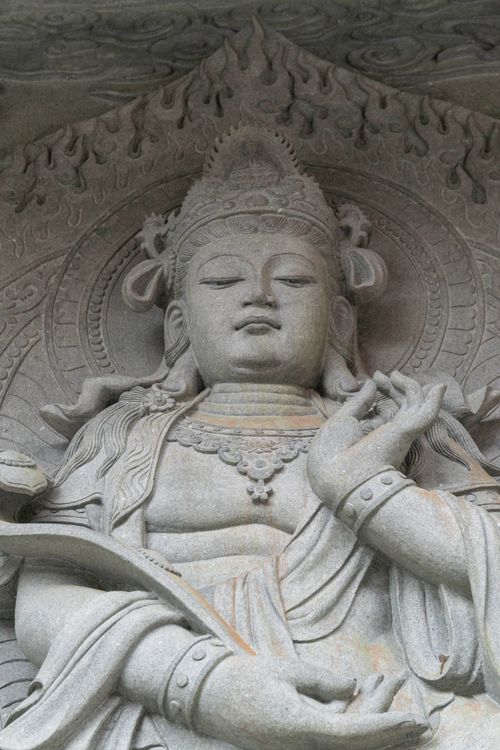 Free Close-up of a detailed stone Buddha carving, depicting spirituality in Hong Kong. Stock Photo