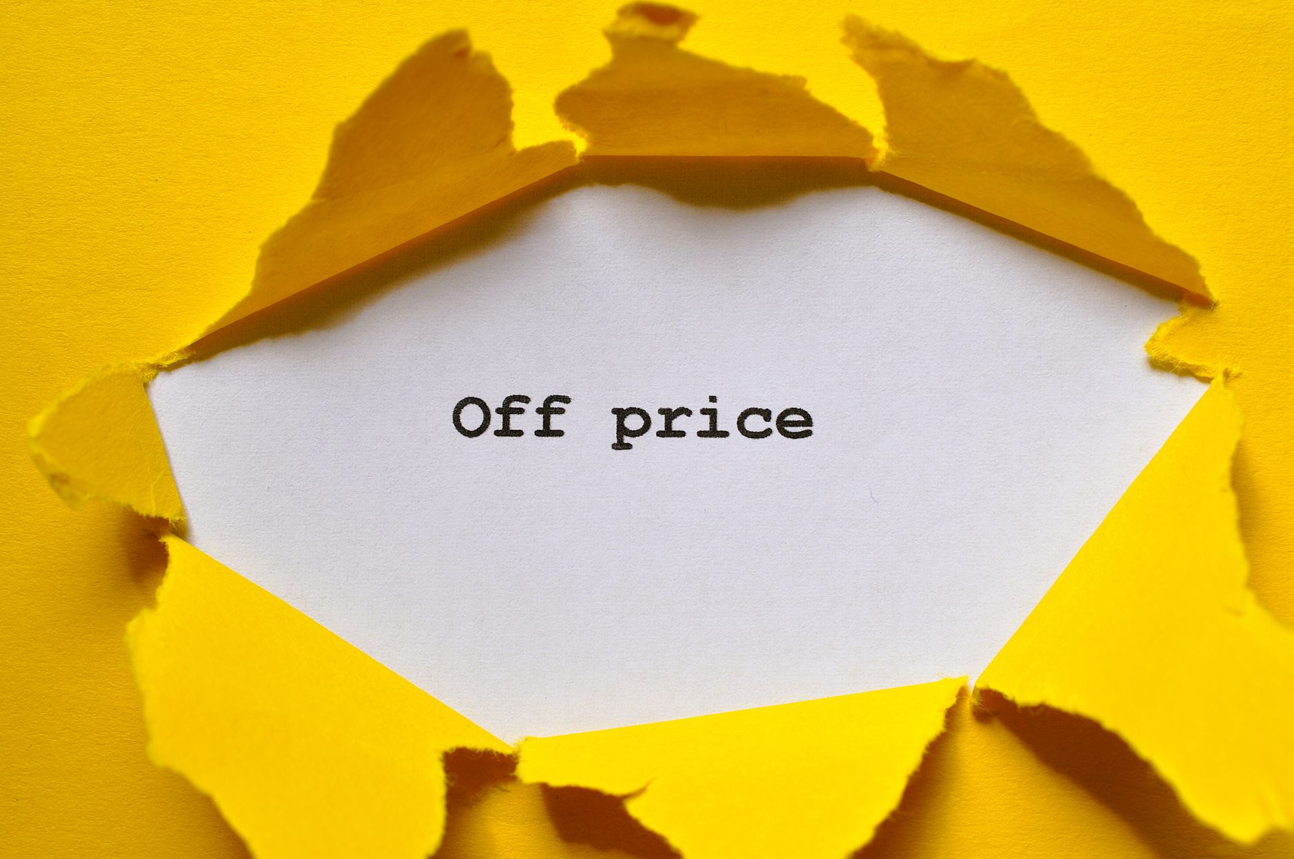Bright yellow paper reveals 'Off Price' text, perfect for sales and promotions.