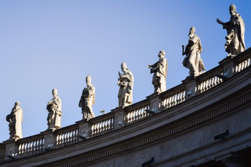 Free Stunning view of statues on St. Peter's Basilica in Vatican City against a clear blue sky. Stock Photo
