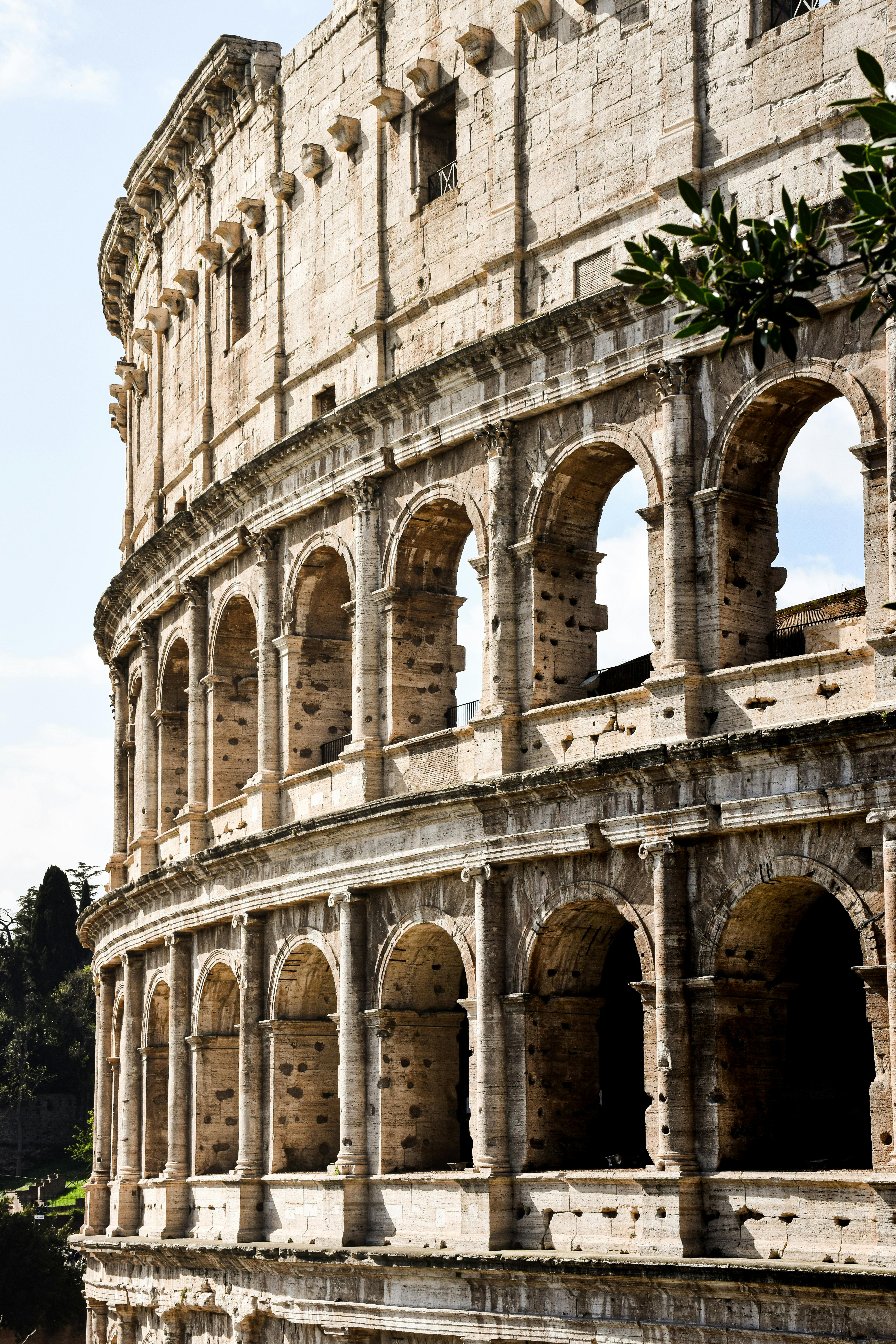 Free Detailed shot of the iconic Colosseum exterior in Rome, highlighting its ancient architecture. Stock Photo