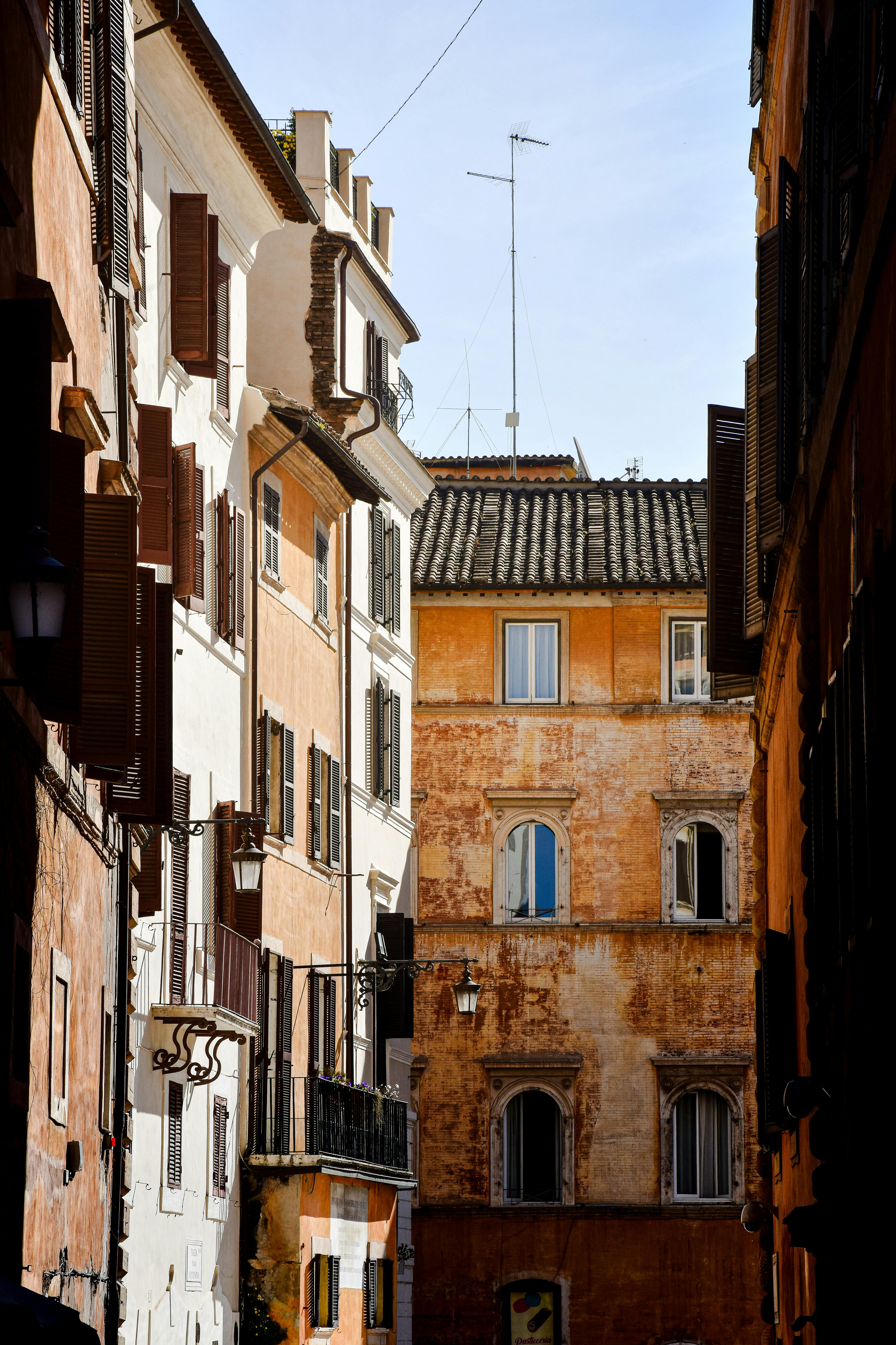 Beautiful narrow street with traditional Roman architecture in Trastevere, Rome, Italy.