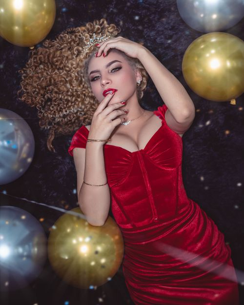 Woman in red velvet midi dress