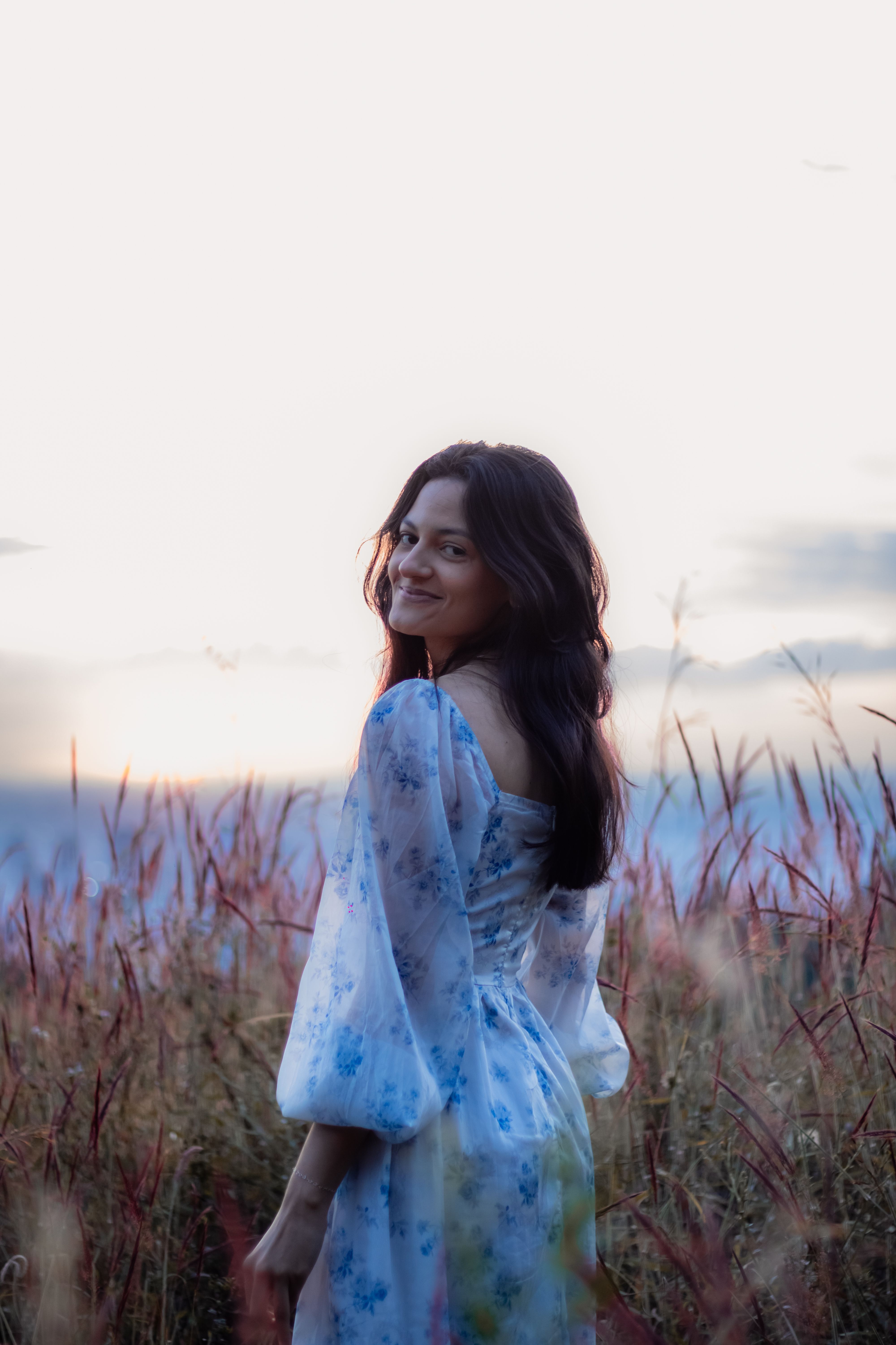 Woman in Floral Dress in Peaceful Sunset Field Free Stock Photo Woman in Floral Dress in Peaceful Sunset Field Free Stock Photo