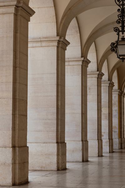 Marble corridor with repeating arches — photo by Ulkar Batista on Pexels