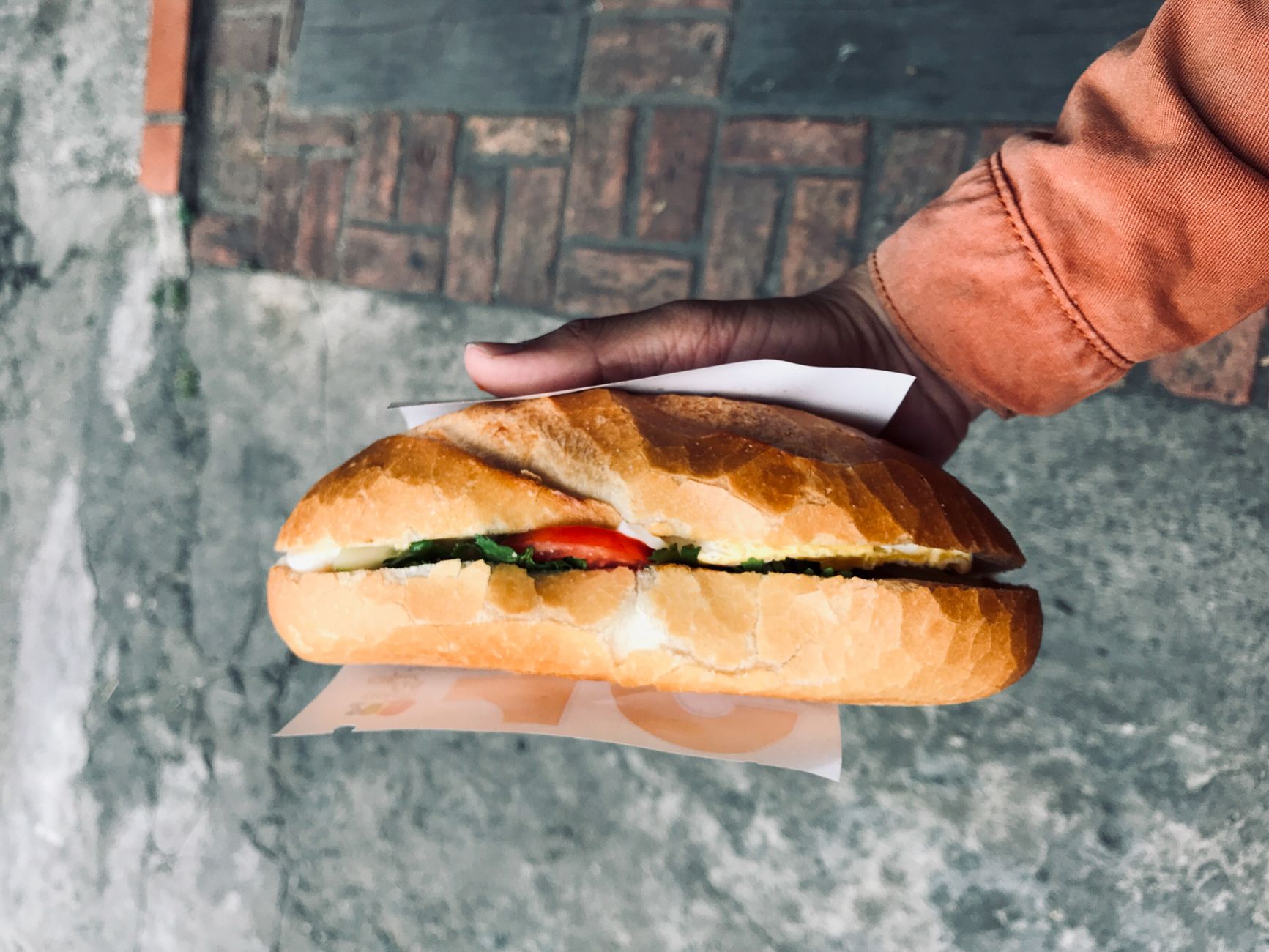 woman eating banh mi street