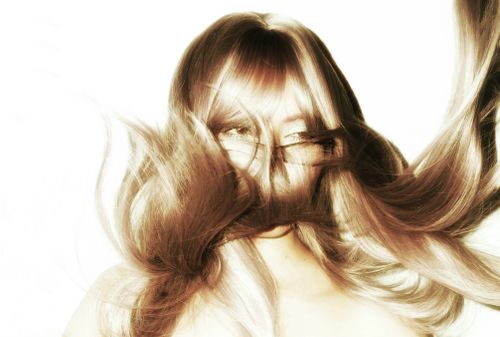 Free Artistic portrait capturing flowing hair with face obscured, creating a dynamic and mysterious visual. Stock Photo