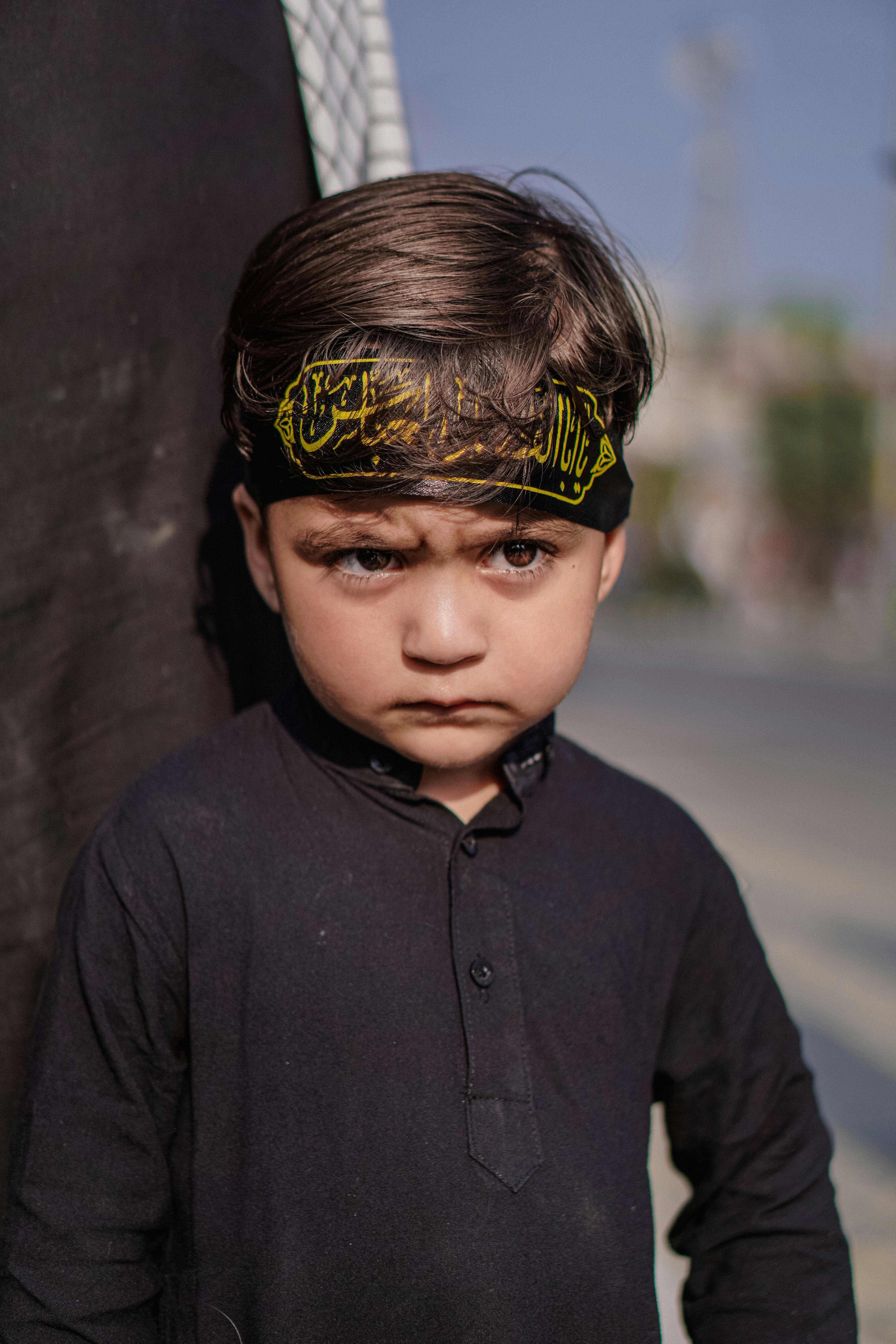 Free Intriguing portrait of a child in traditional attire captured outdoors in Srinagar. Stock Photo