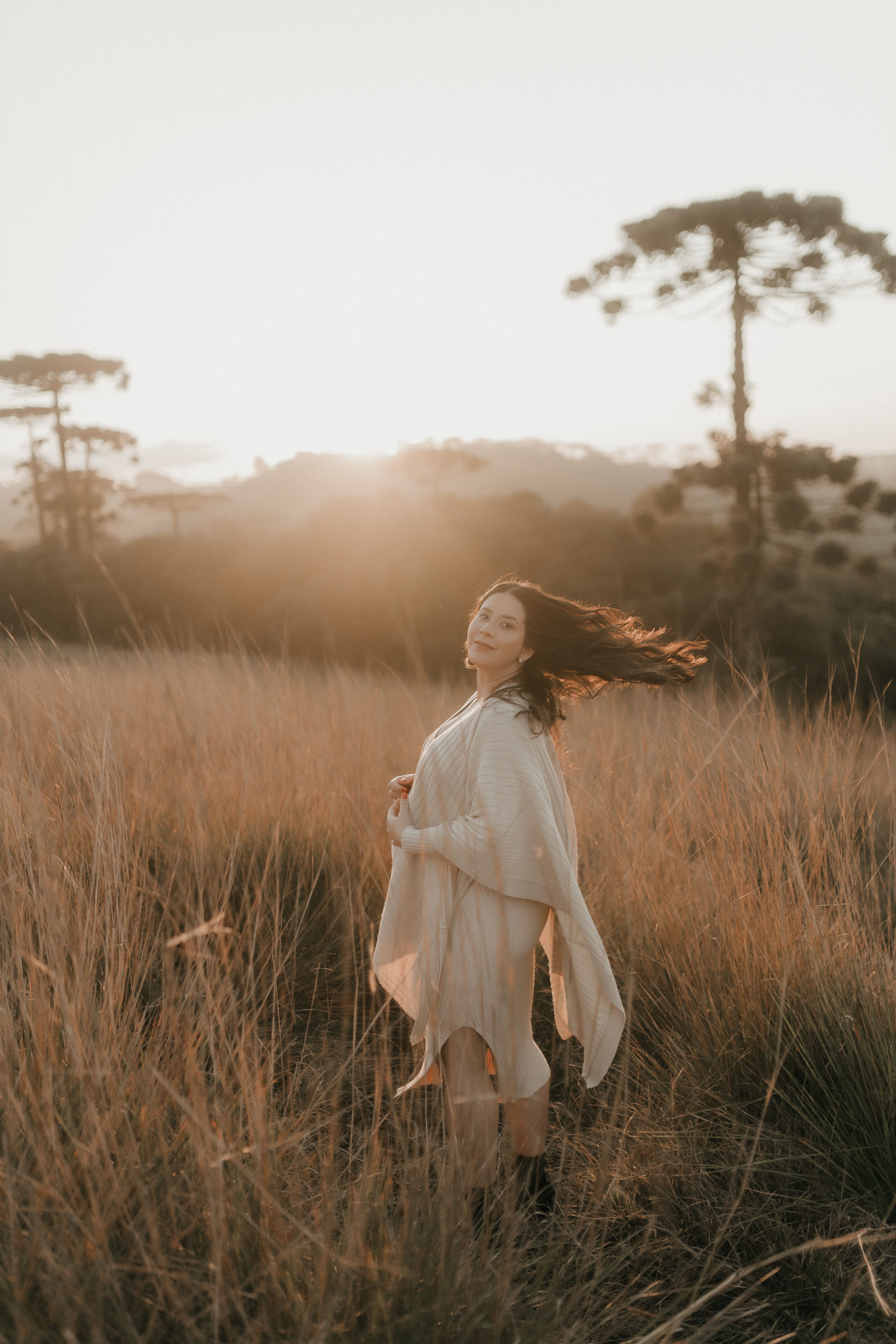 Serene Woman in Grassy Field at Sunset · Free Stock Photo