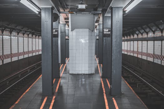 A deserted view of the Wall Street subway station platform in New York City.