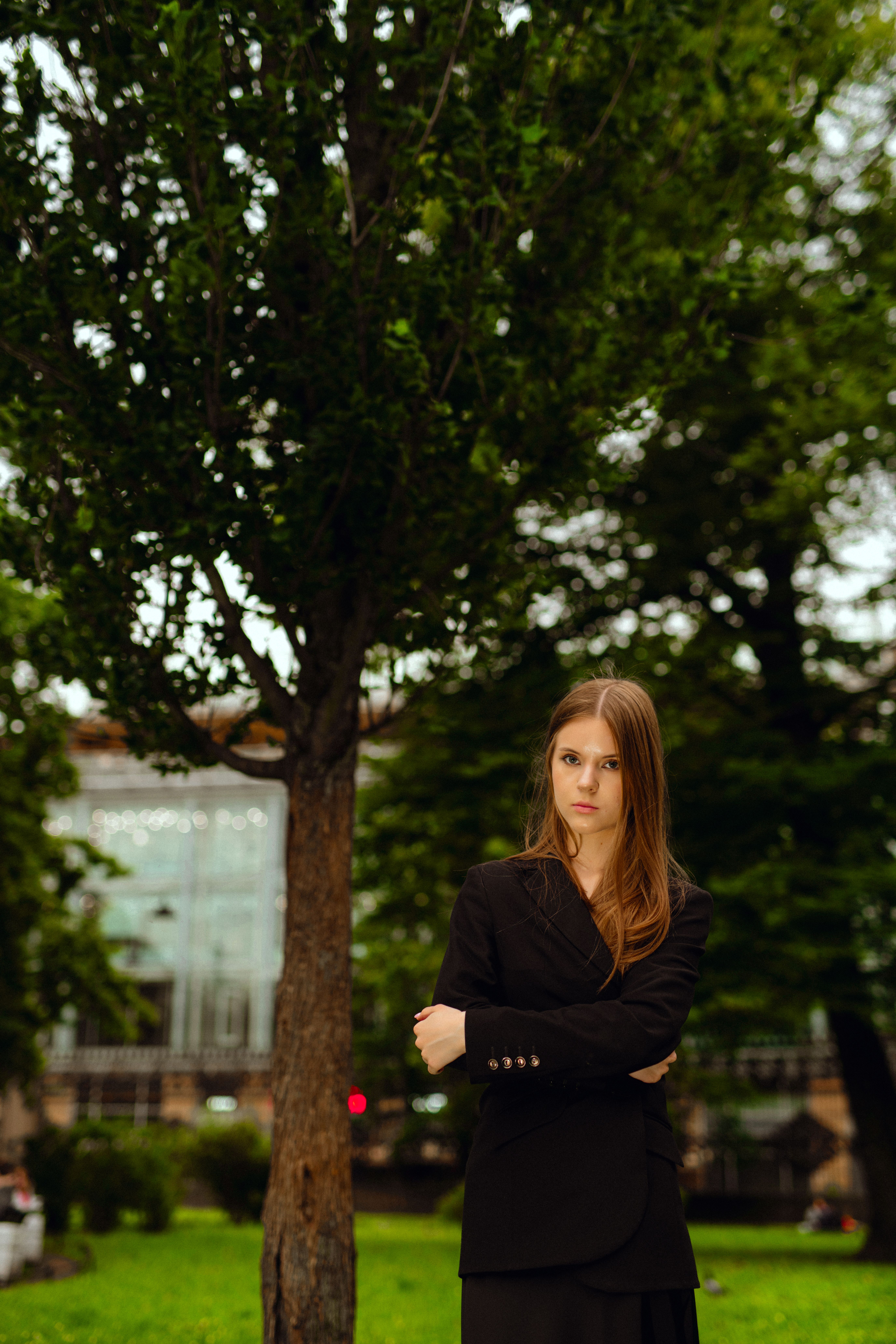 Elegant Woman Posing in Urban Park Setting · Free Stock Photo