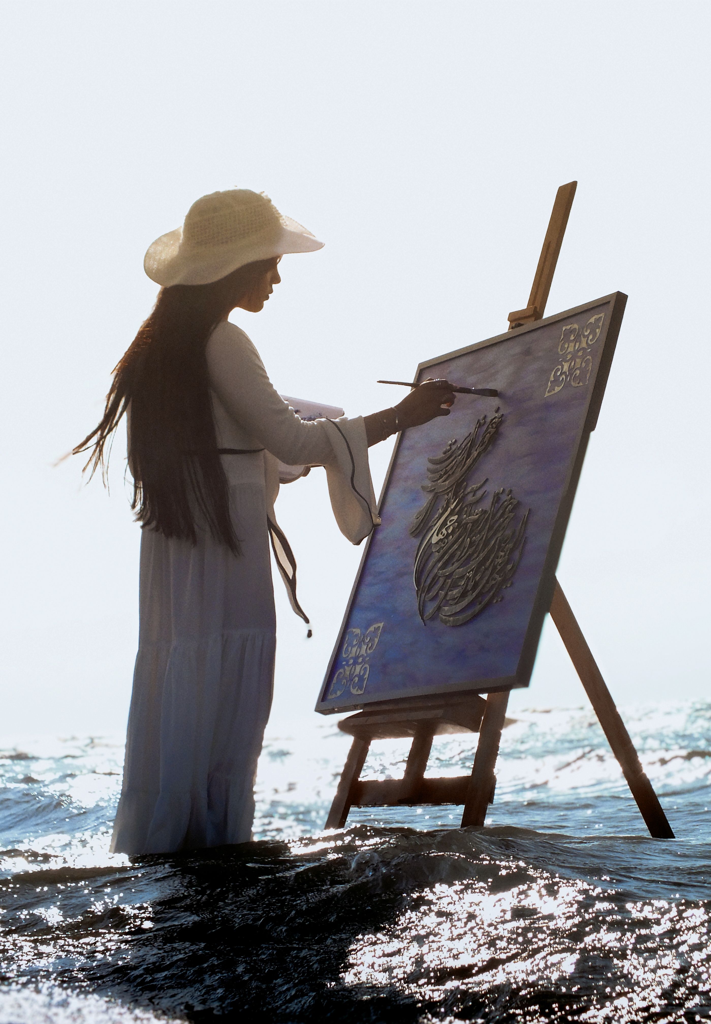 Woman Painting Seascape on an Easel at the Beach · Free Stock Photo