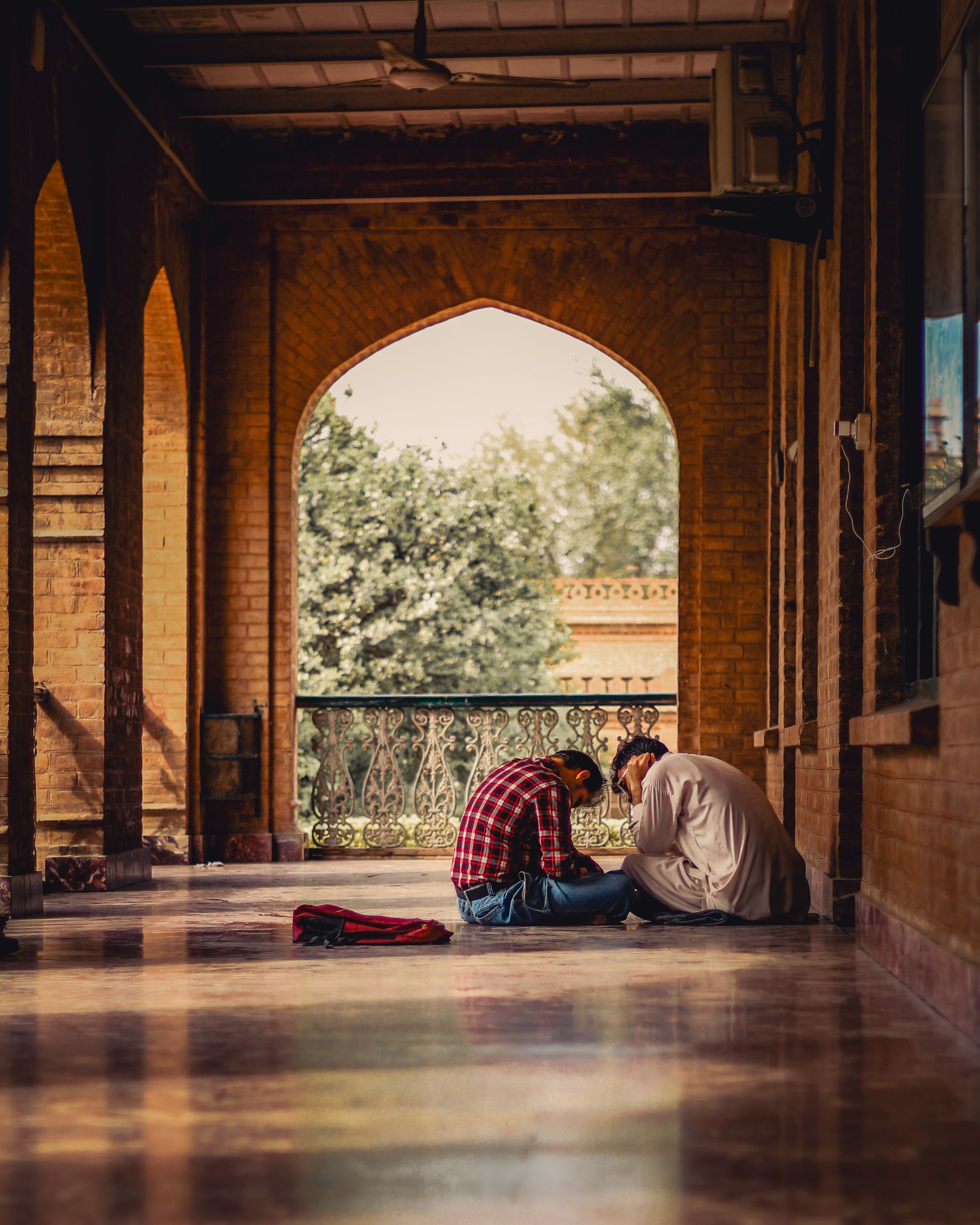 Two students studying in a historic corridor in Peshawar, Pakistan