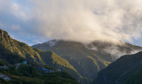 Serene mountain scene with misty clouds in Tasmania, Australia.