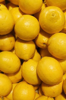 Vibrant close-up of ripe lemons, showcasing their bright yellow color and smooth texture.