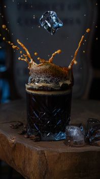 A dramatic splash of cold brew coffee with ice, showcasing vibrant action and rich textures.