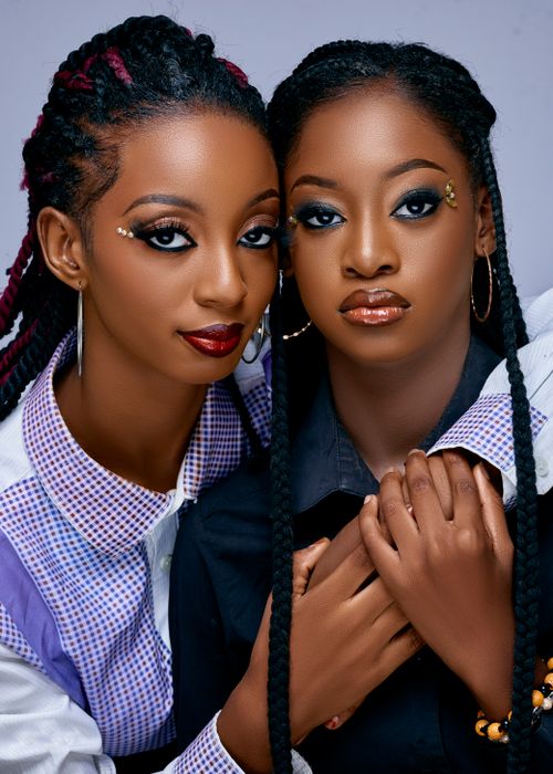 Free Close-up portrait of two stylish young women with makeup and braids, embracing each other. Stock Photo