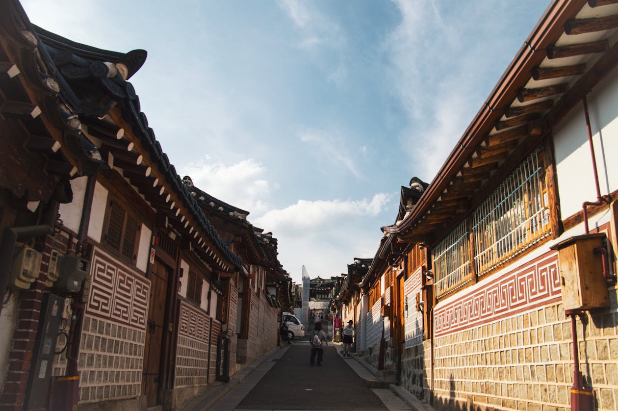 Traditional Korean neighborhood street in Seoul with small shops and cafes
