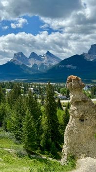 Experience the breathtaking landscape of the Canadian Rockies with lush forests and unique hoodoo formations.