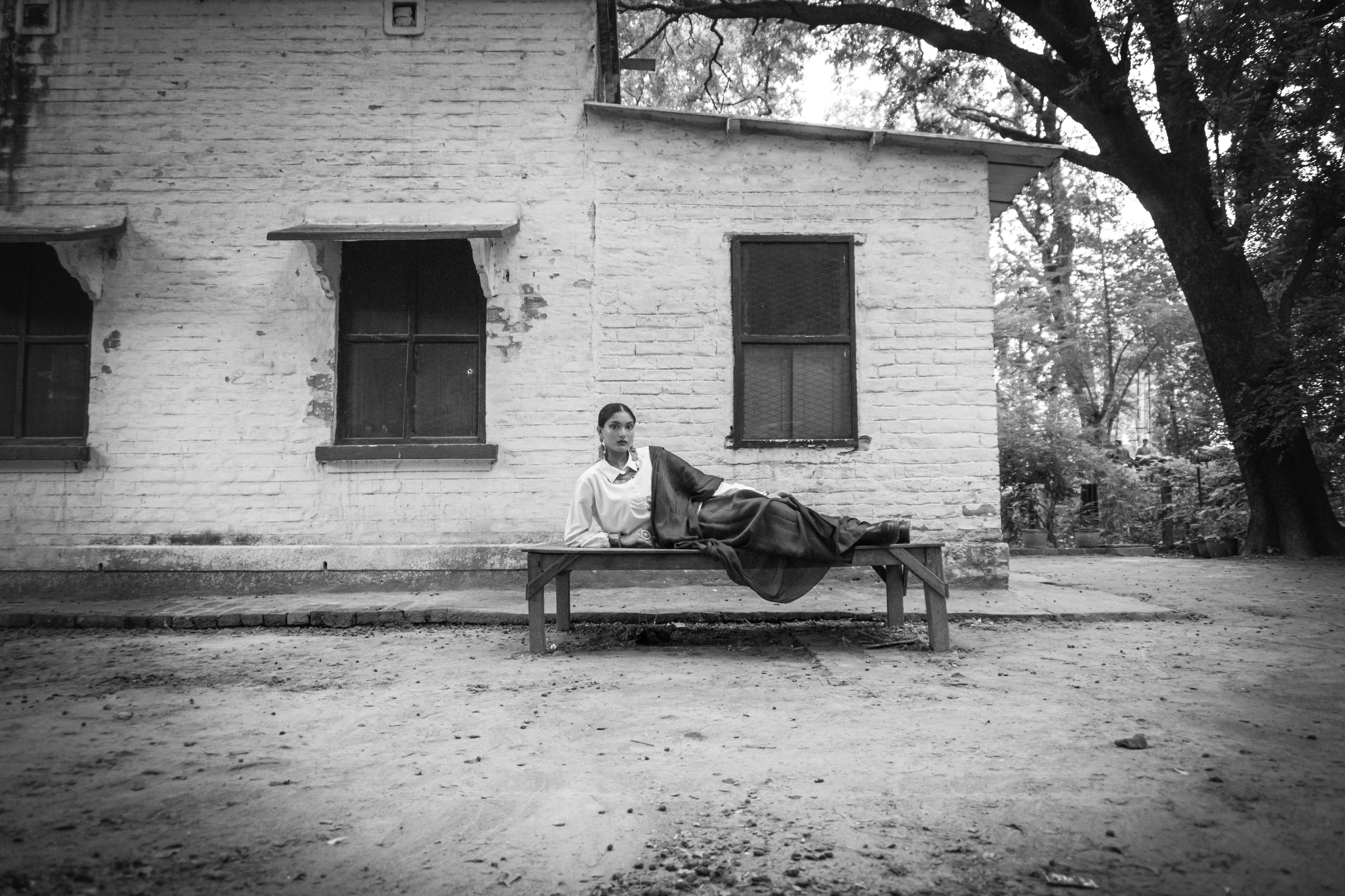 Elegant woman in traditional saree posing outdoors, conveying timeless beauty and cultural style.