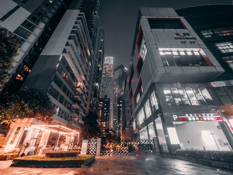 Dynamic cityscape at night featuring towering skyscrapers and illuminated streets.